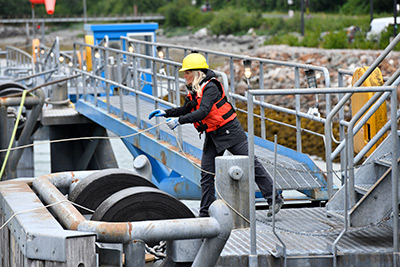 AMHS employee on the ramp tying up a ship