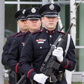 guards in formal uniforms at a memorial service