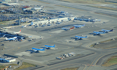 Bird's eye view of the terminal, the tarmac, parked planes, and the runway at Ted Stevens Anchorage International Airport. Photo by Rob Stapleton