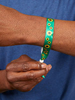 man holding a sunflower program wristband