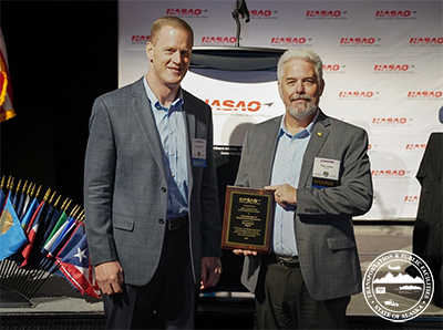 Former Deputy Commissioner John Binder, and Division Operations Manager Troy LaRue accepting the award at the NASAO Conference.
