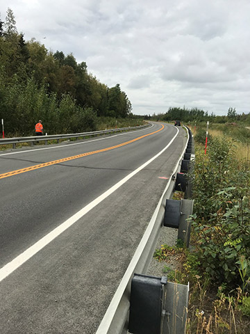 Dip in the roadway on KGB Road due to material loss in the embankment.