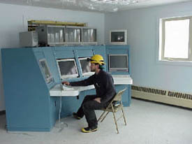 Technician working on control console in Tunnel Control Center. April 2000. 