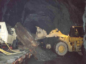 Base material unloaded from railcar in Anton Anderson Memorial Tunnel.