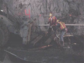 Kiewit workers remove old ties from the tunnel. 