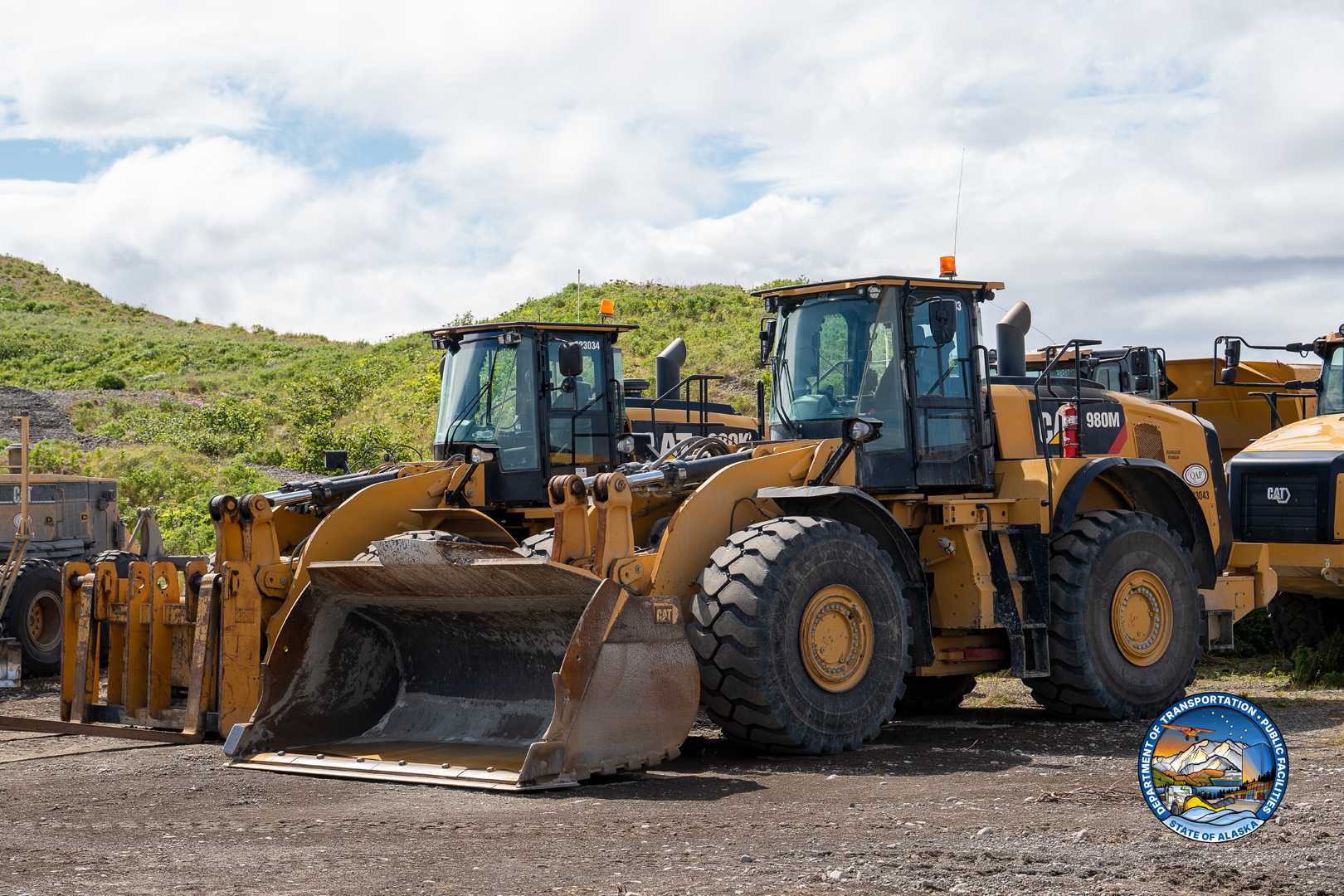 Heavy equipment staged at a material site near King Cove