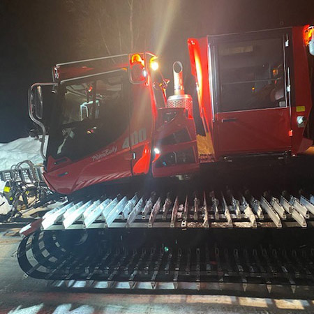 red Piston Bully 400 grooming machine parked in the evening