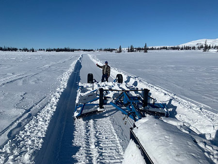 snowmachine trail grooming on a lake