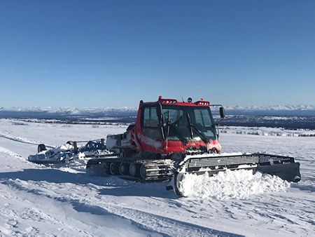 snowmachine trail grooming on a lake