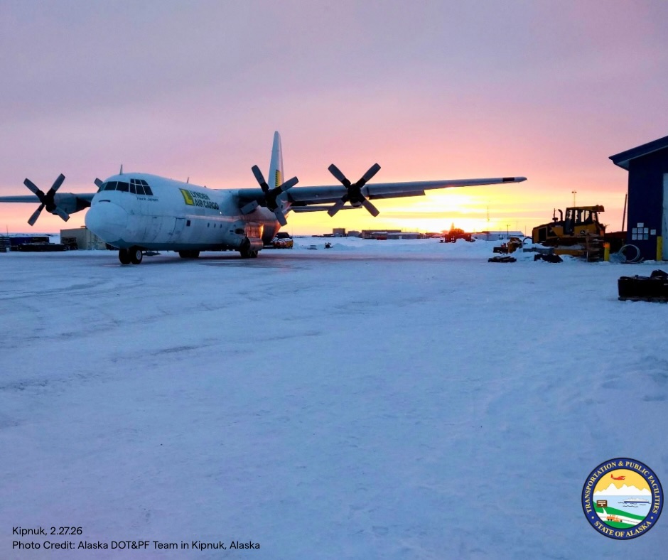 Lynden Air Cargo plane on a snowy tarmac in Kipnuk with sunrise in background