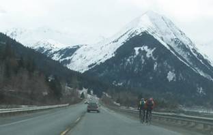 Motorist passing cyclists on the shoulder,