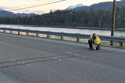 Traffic pressure sensors being placed on a roadway