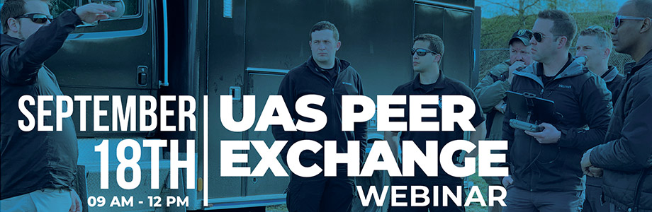 UAS Peer Exchange banner showing a group of men standing next to a truck in discussion